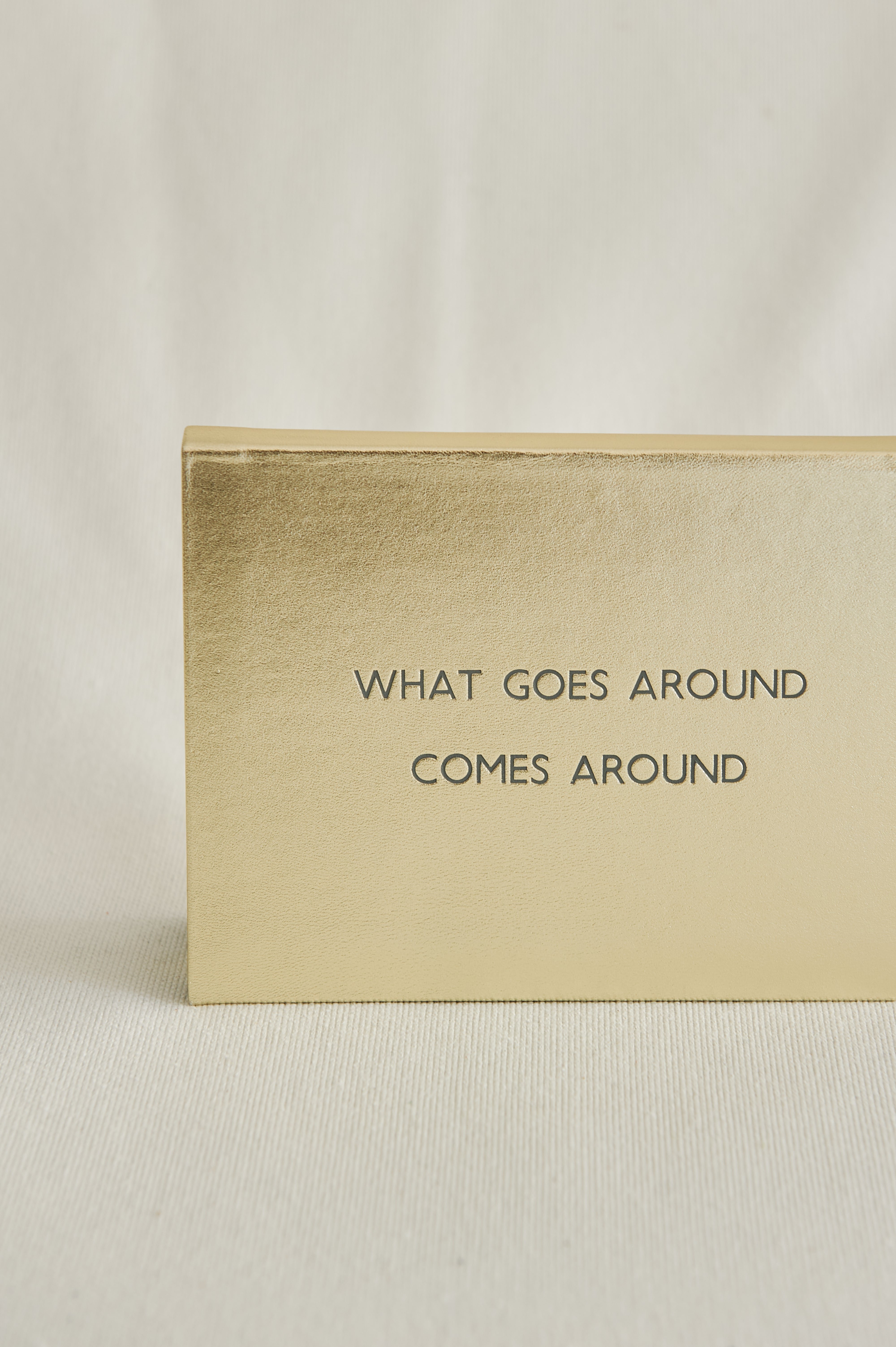 CUADERNO PIEL DORADO "WHAT GOES AROUND COMES AROUND"